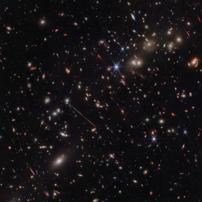 Webb’s infrared image of the galaxy cluster El Gordo (“the Fat One”) reveals hundreds of galaxies, some never before seen at this level of detail. El Gordo acts as a gravitational lens, distorting and magnifying the light from distant background galaxies. Image: NASA, ESA, CSA.